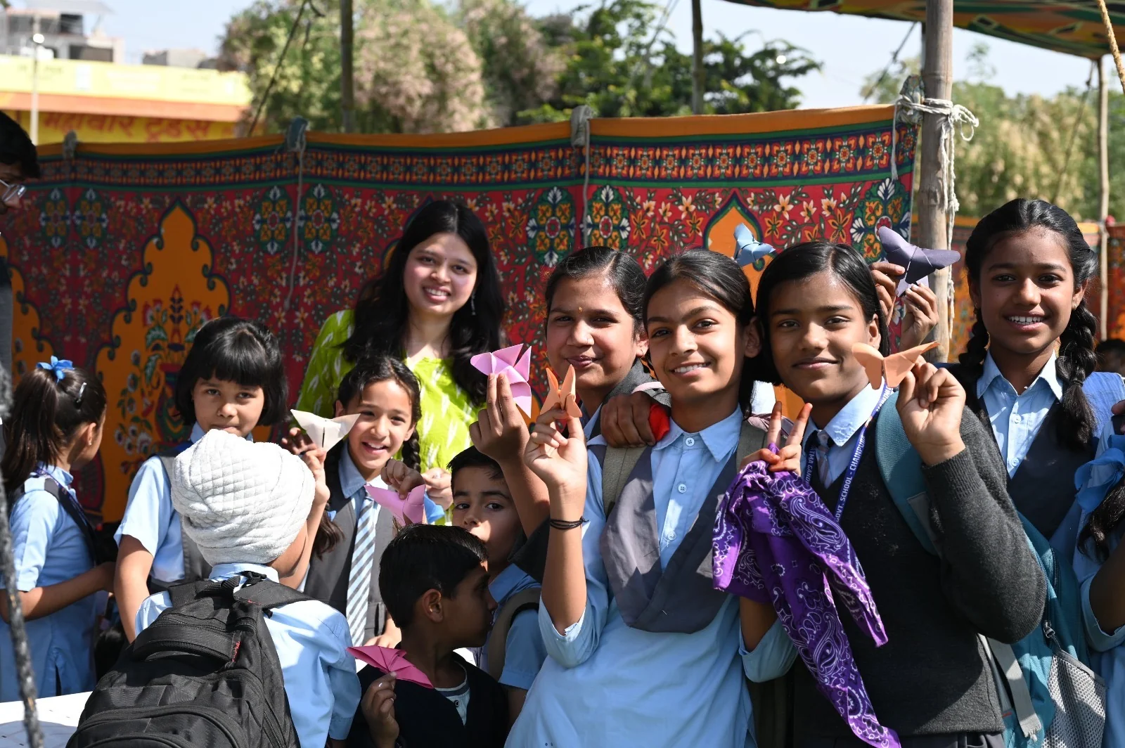 Students and volunteers smiling together at the fair