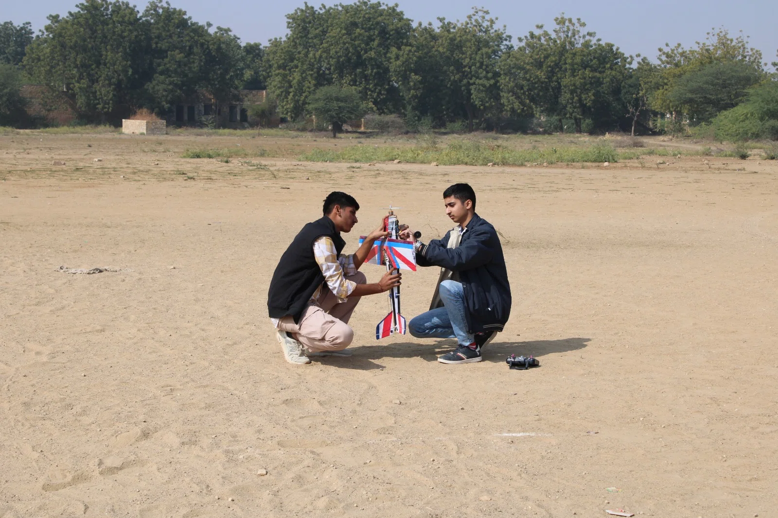 Students watching a small outdoor demonstration