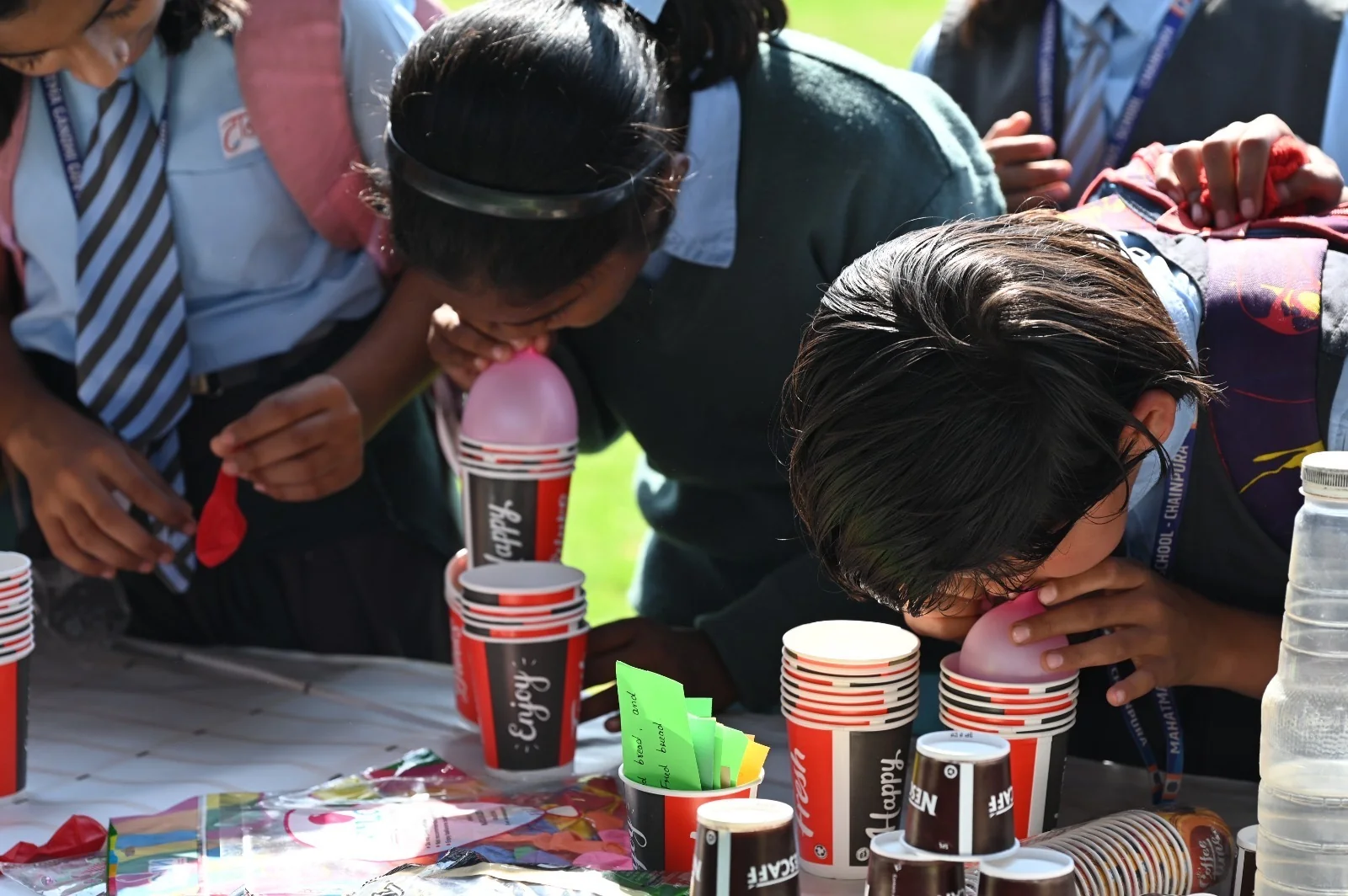 Students concentrating on a hands-on challenge at the fair