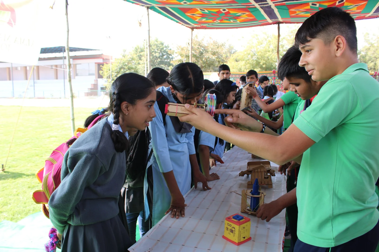 A student trying a hands-on activity at a learning stall