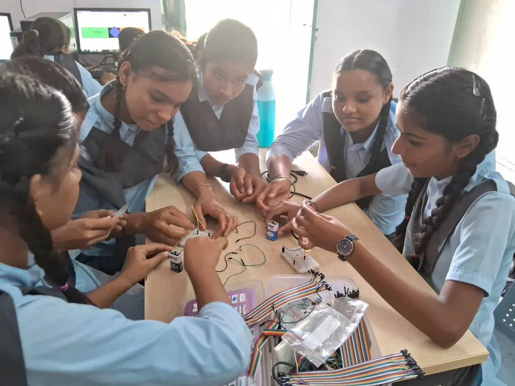 Students building and testing a robotics project