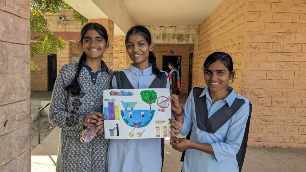 Students presenting environmental awareness posters